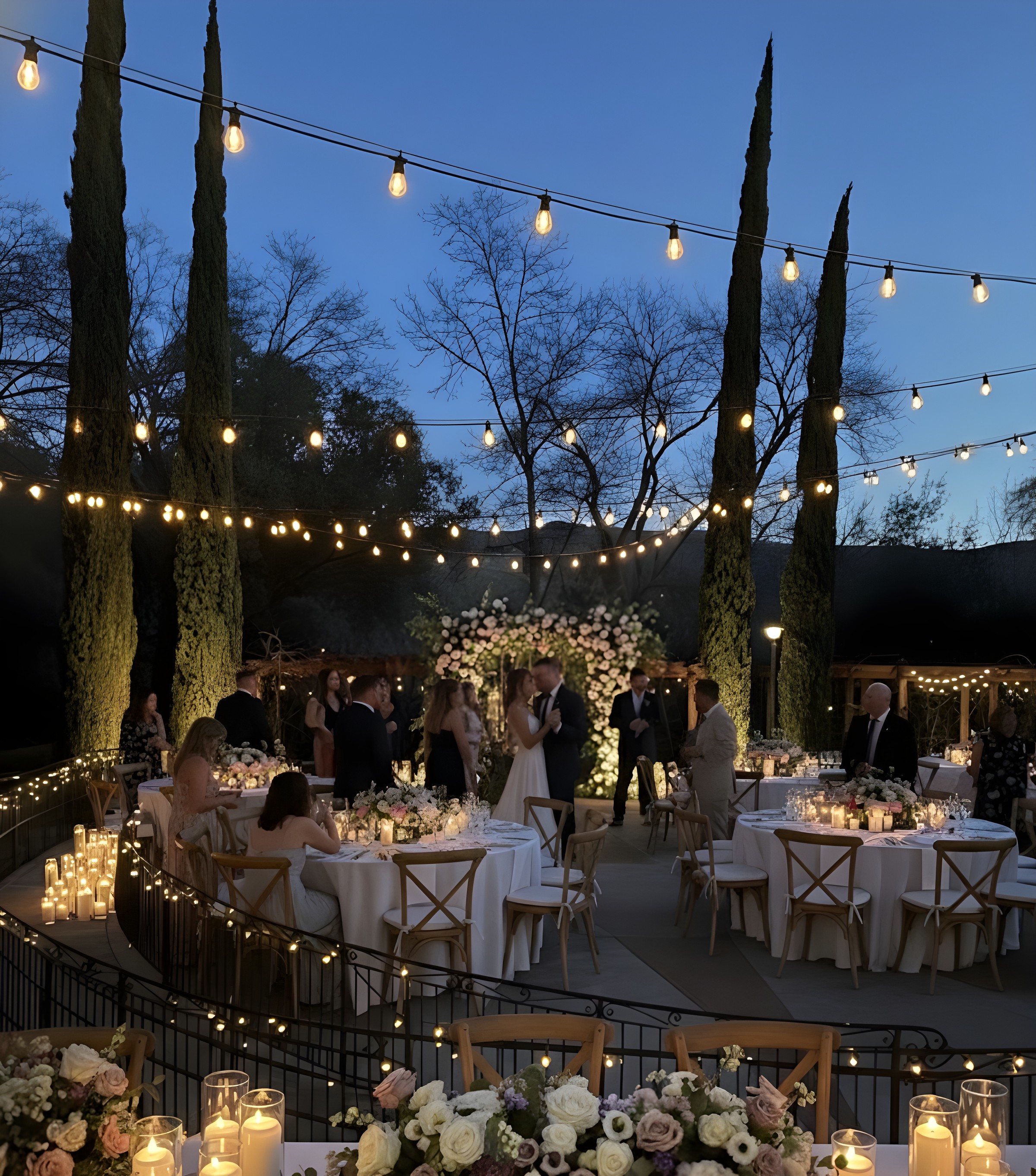 Wedding reception at ELDO — string lights, candlelit tables, floral arch